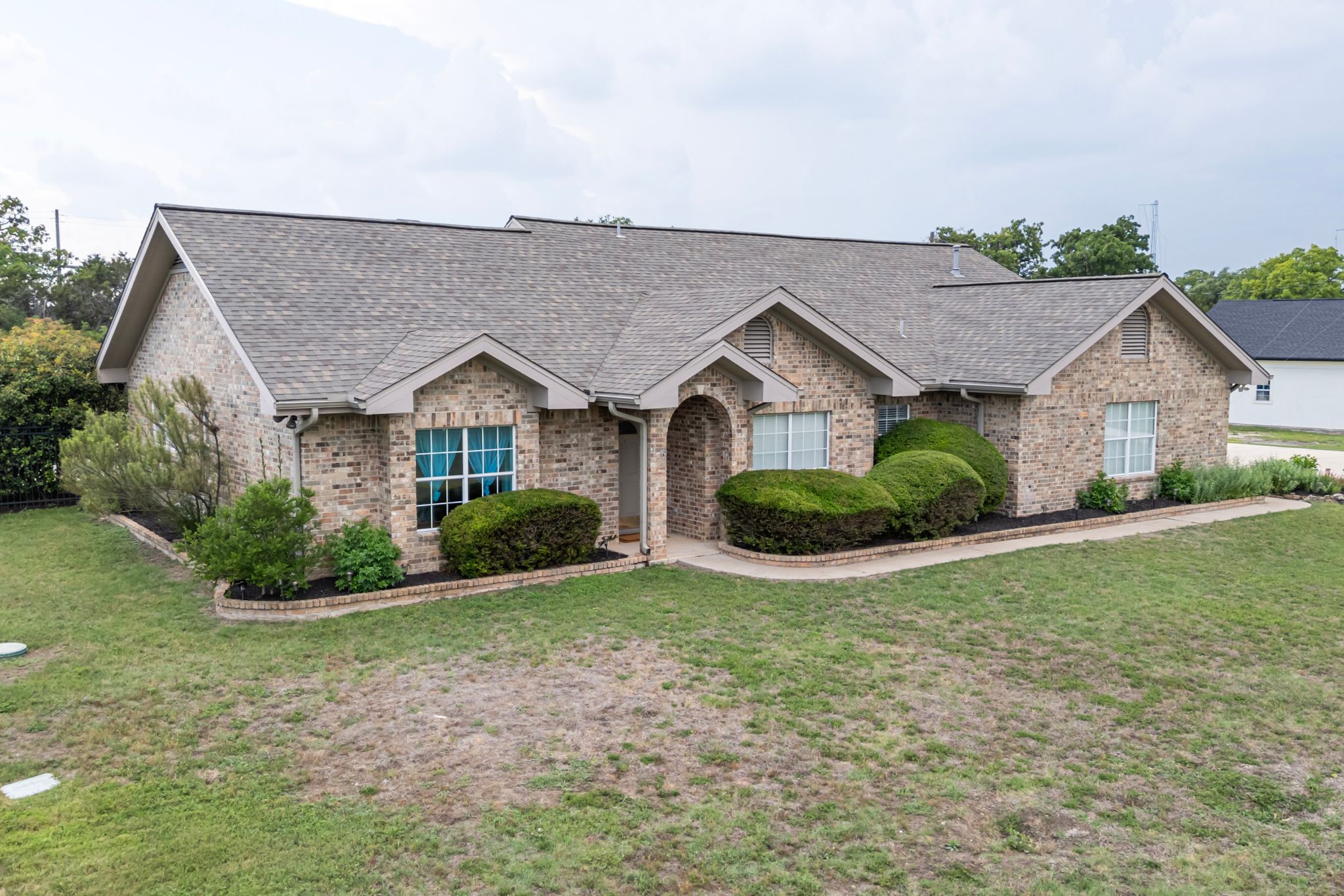221 Breakaway Road Cedar Park, TX 78613 - Photo 2 of 39 Ranch-style house featuring a shingled roof, brick siding, and a front yard