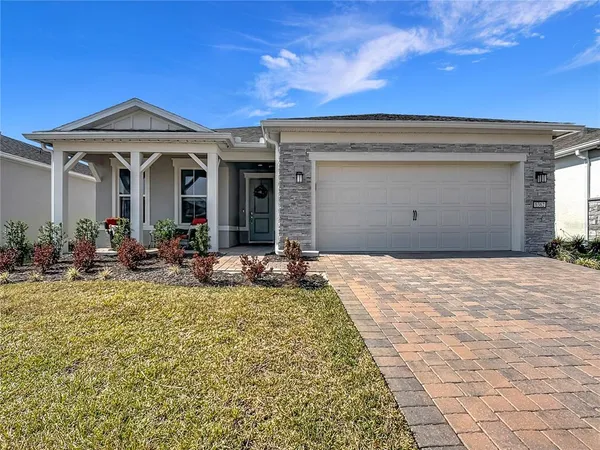 a view of a house with patio outdoor dining space and garden view
