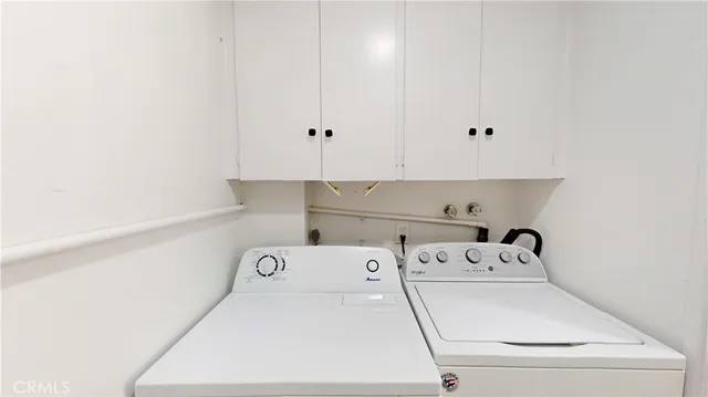 a view of storage and utility room with washer and dryer
