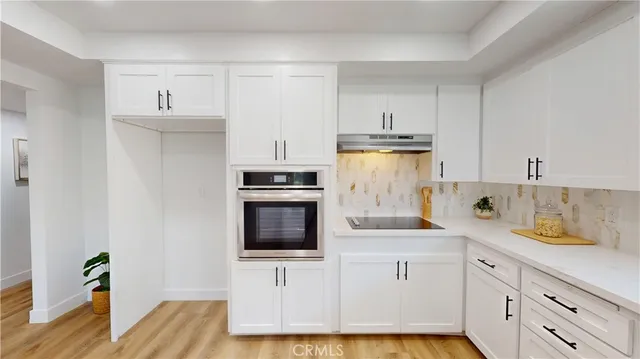 a living room with furniture kitchen view and a fireplace