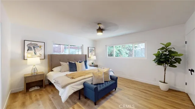 a bedroom with a bed and a large window