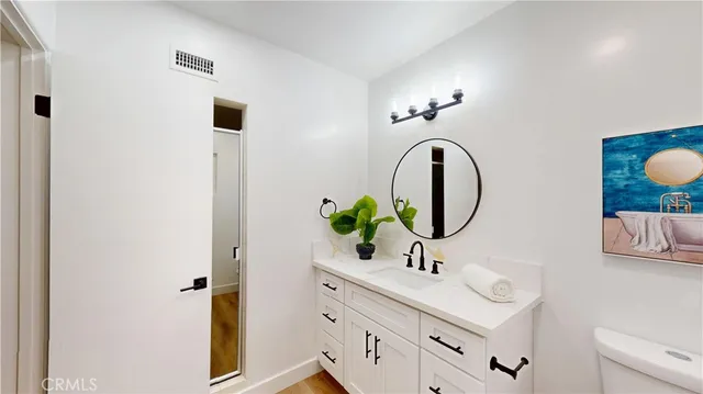 a bedroom with furniture and a potted plant