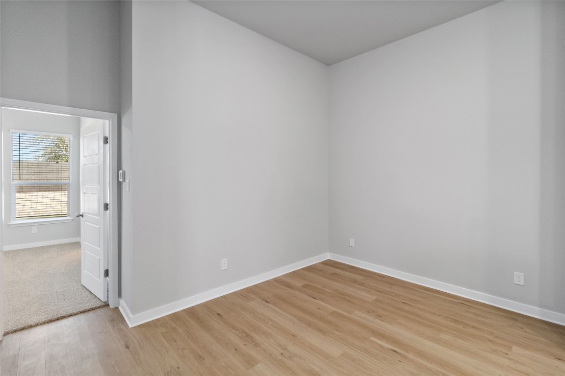 840 Staglin Street, Unit B Buda, TX 78610 - Photo 11 of 17 Empty room featuring light wood-style floors