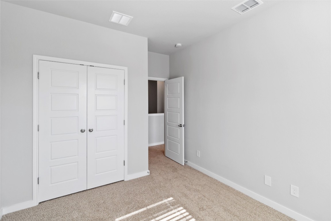 840 Staglin Street, Unit B Buda, TX 78610 - Photo 14 of 17 Unfurnished bedroom with carpet flooring and a closet