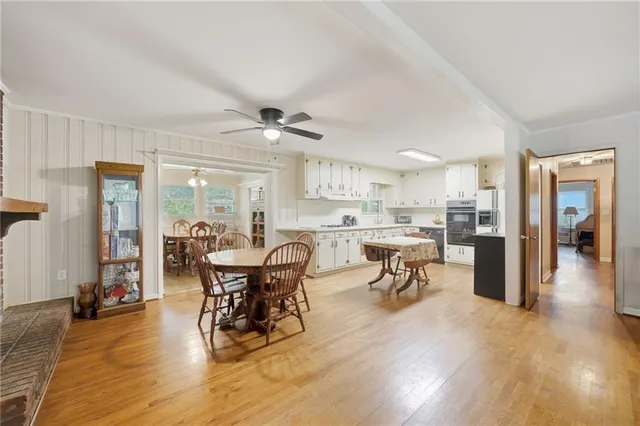 a view of a dining room with furniture and wooden floor