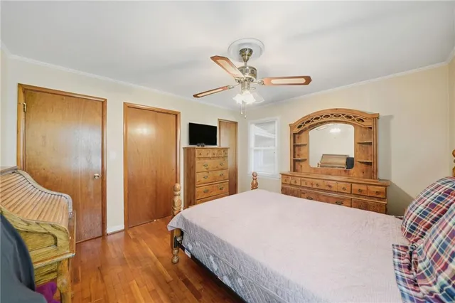 a bedroom with a large bed and a chandelier