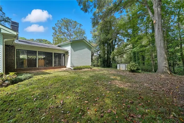 a view of a house with a backyard
