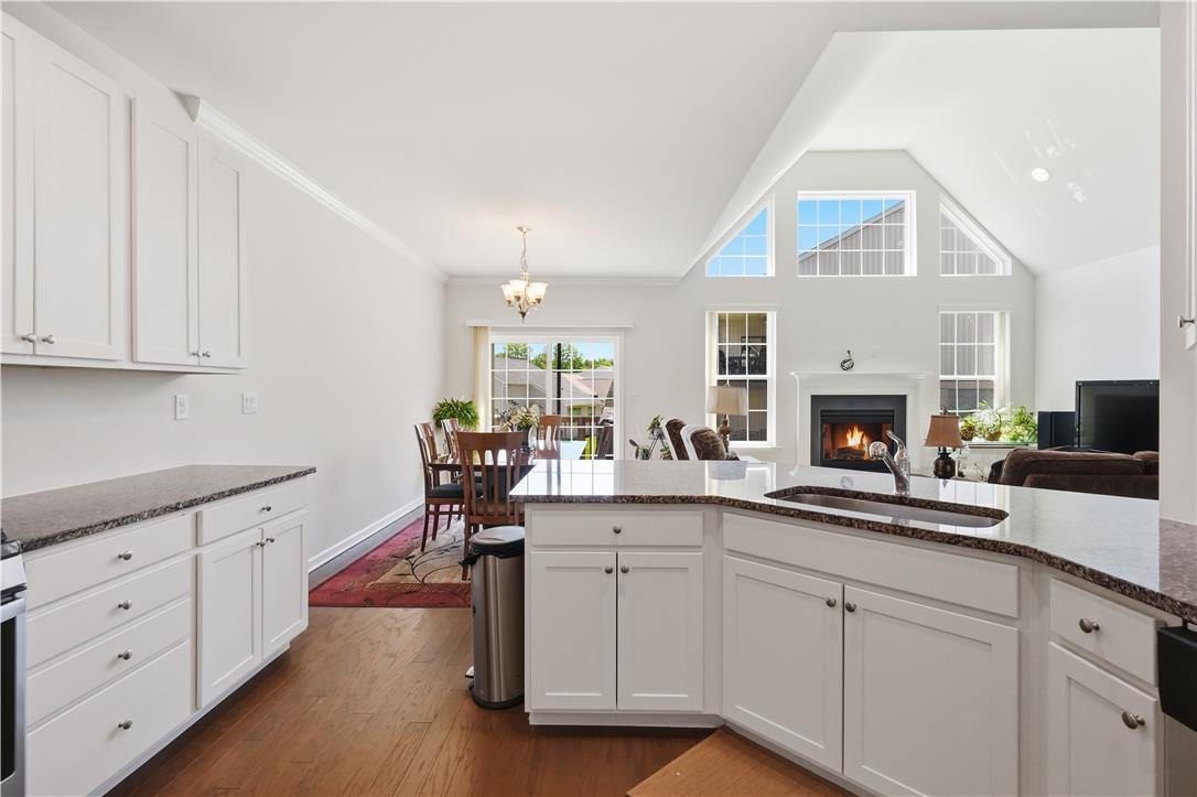 4120 Eveningstar Road Emmaus, PA 18049 - Photo 12 of 62 An open-concept living space integrates a well-appointed kitchen with dining and living areas, creating an inviting flow.
