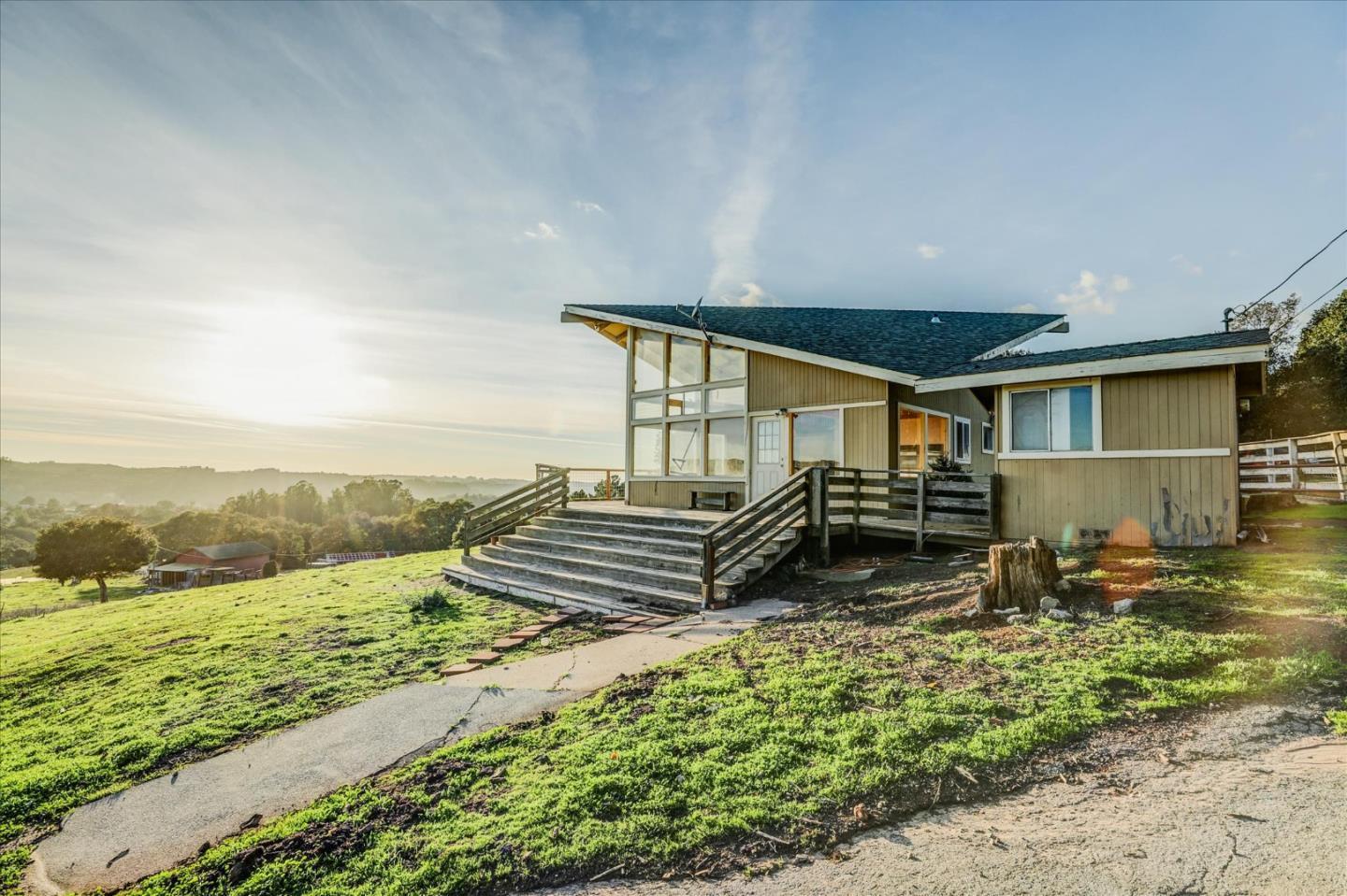 a backyard of a house with a yard and outdoor seating