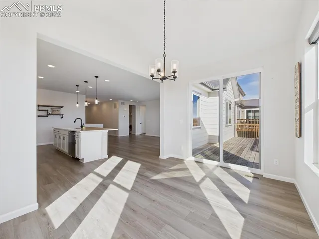 a large white kitchen with a sink and a stove top oven