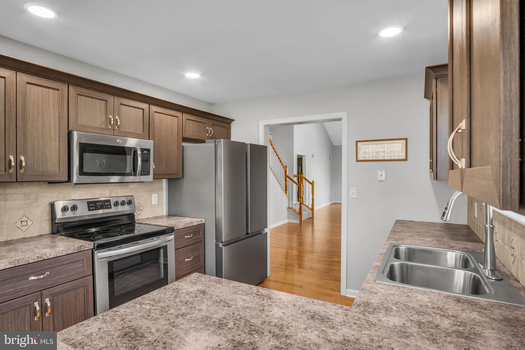 2 Round Ridge Road Mechanicsburg, PA 17055 - Photo 14 of 35 a kitchen with stainless steel appliances granite countertop a refrigerator a stove and a sink