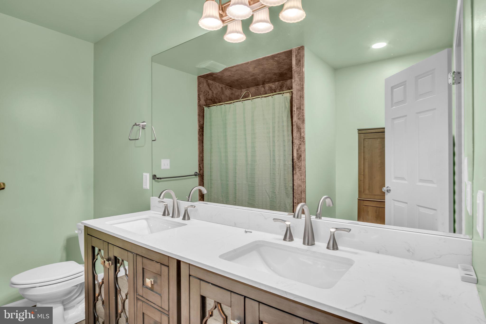 2 Round Ridge Road Mechanicsburg, PA 17055 - Photo 21 of 35 a bathroom with a granite countertop sink a toilet and a large mirror