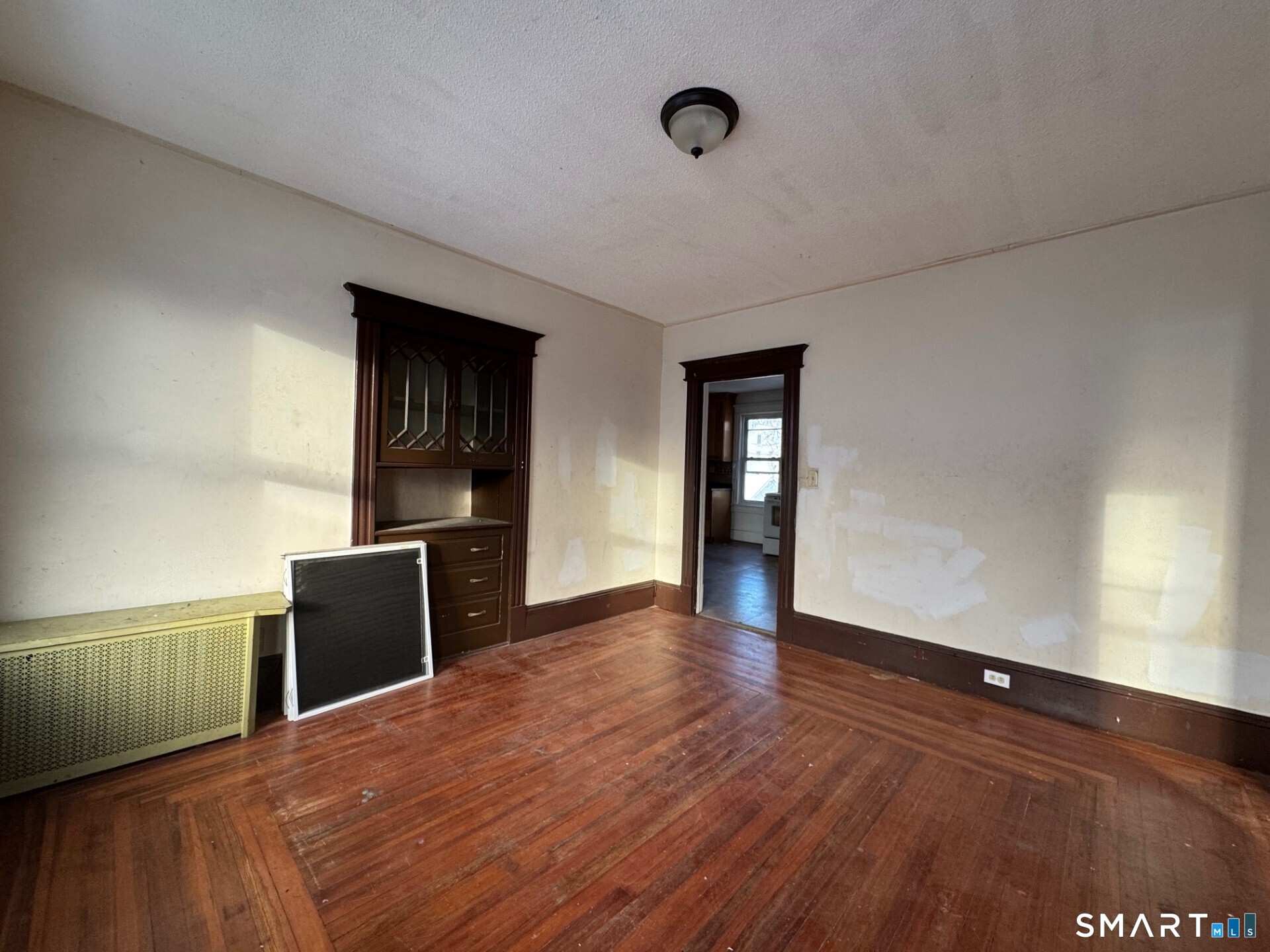 231 School Street Manchester, CT 06040 - Photo 13 of 37 a view of a livingroom with wooden floor and a ceiling fan