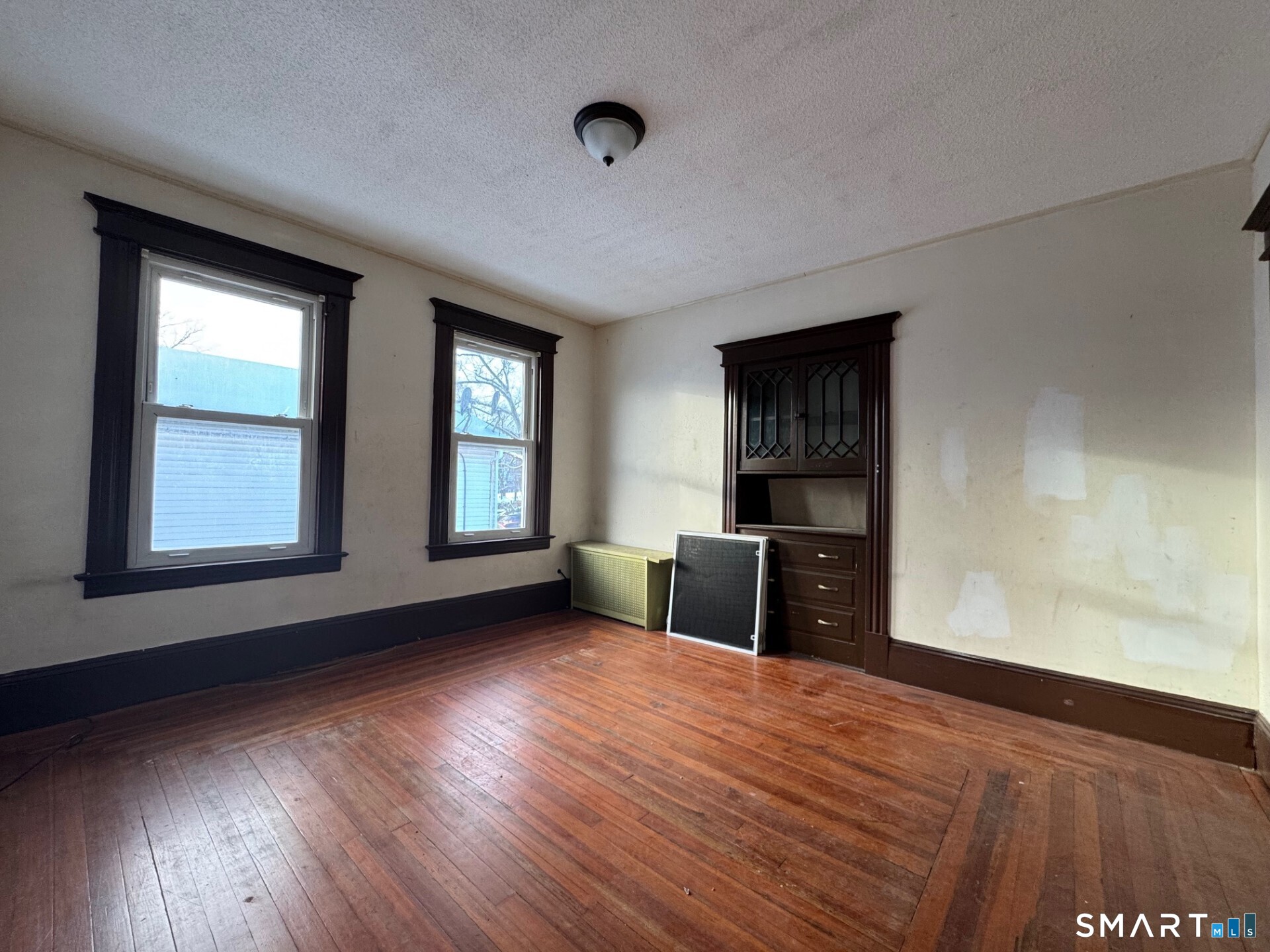 231 School Street Manchester, CT 06040 - Photo 14 of 37 a view of an empty room with wooden floor and a window