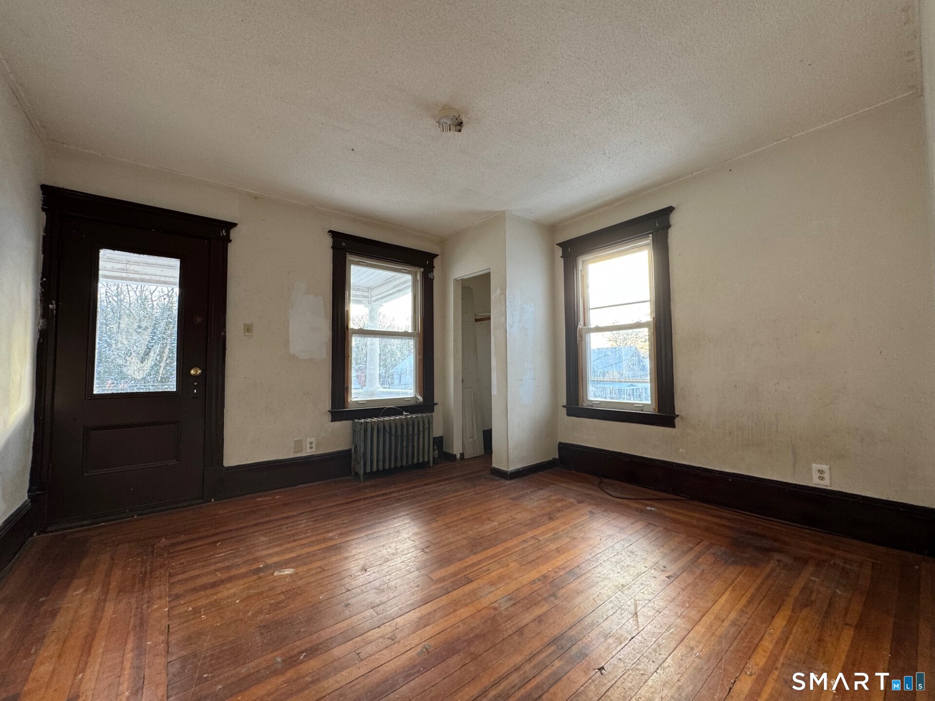 231 School Street Manchester, CT 06040 - Photo 15 of 37 a view of an empty room with wooden floor and a window