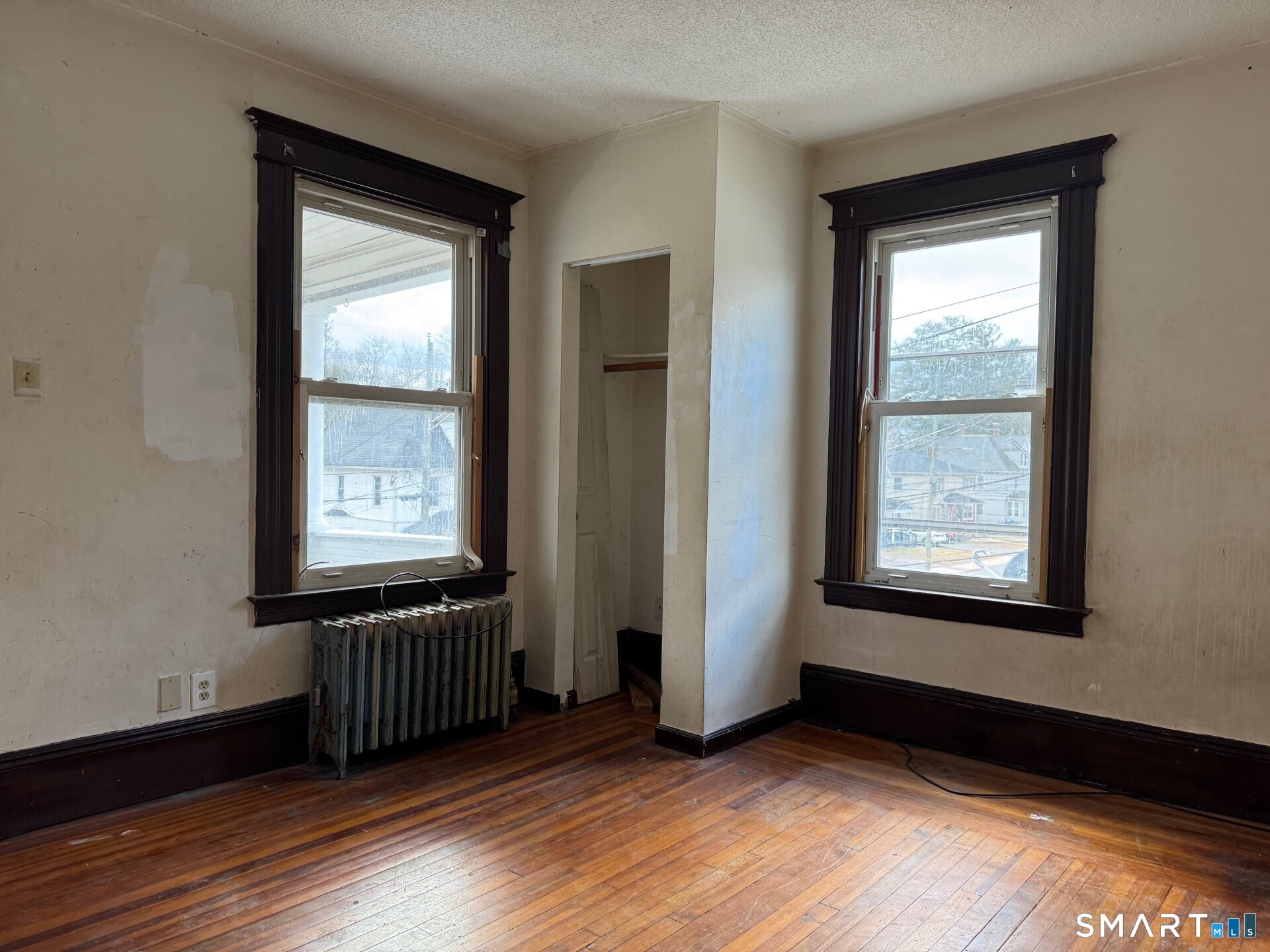 231 School Street Manchester, CT 06040 - Photo 16 of 37 a view of an empty room with wooden floor and a window