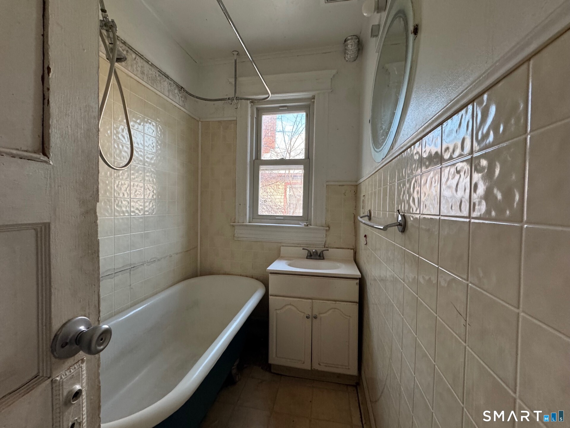 231 School Street Manchester, CT 06040 - Photo 21 of 37 a bathroom with a granite countertop sink a toilet and shower