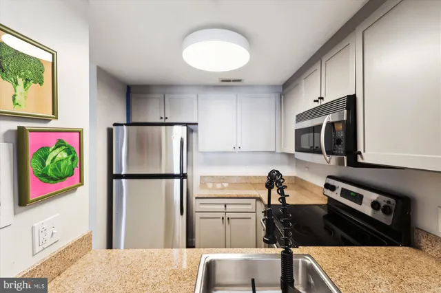 a kitchen with a stove microwave and sink