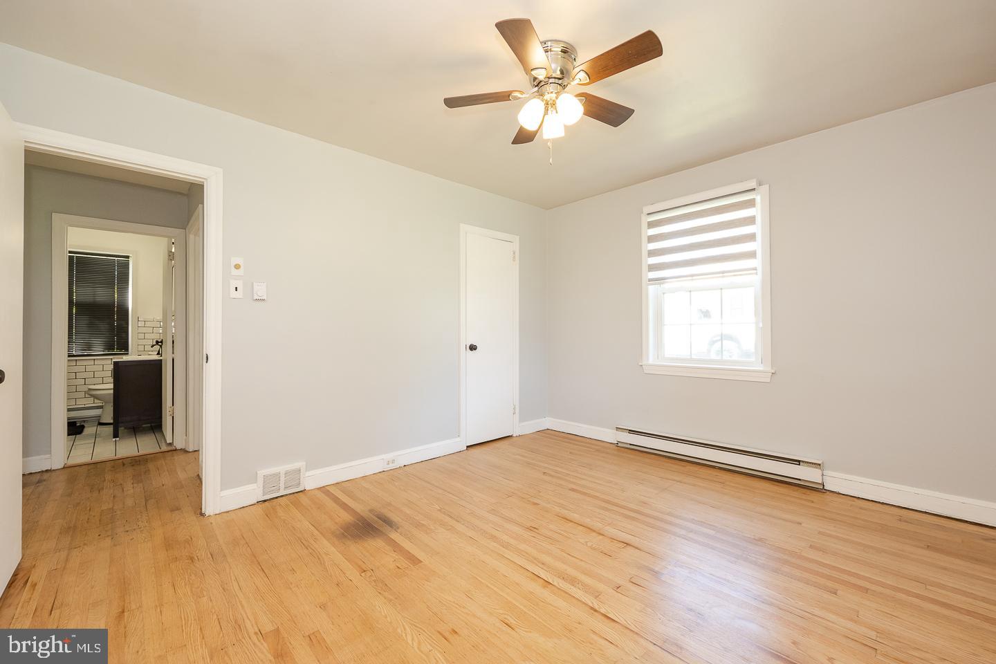 312 Lawrence Road Broomall, PA 19008 - Photo 15 of 23 an empty room with wooden floor and windows
