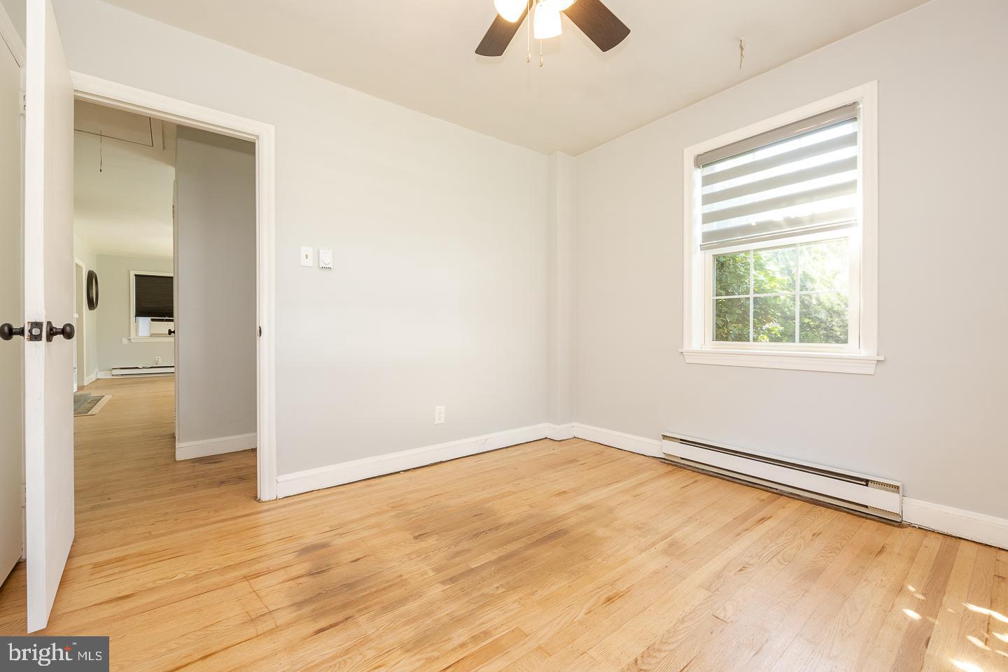 312 Lawrence Road Broomall, PA 19008 - Photo 16 of 23 wooden floor in an empty room with a window