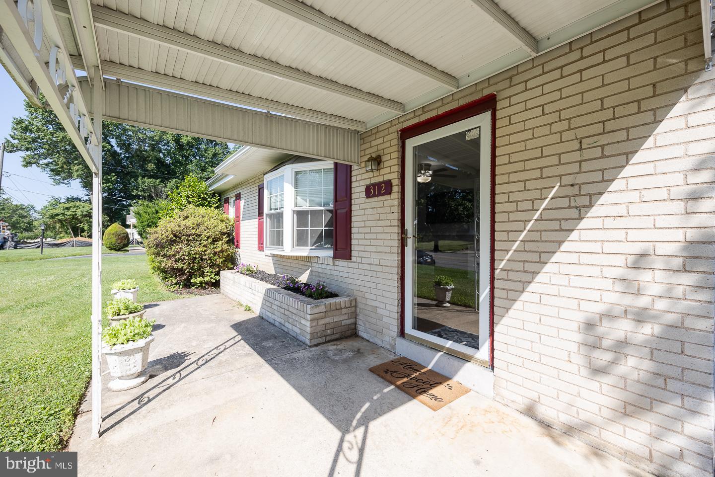 312 Lawrence Road Broomall, PA 19008 - Photo 2 of 23 a view of a patio with table and chairs and potted plants