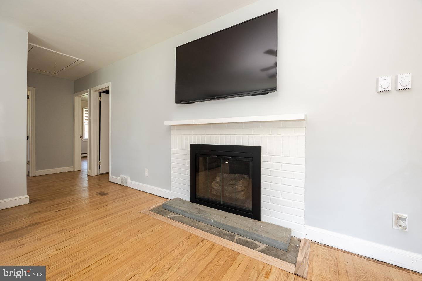 312 Lawrence Road Broomall, PA 19008 - Photo 5 of 23 a living room with a fireplace and a flat screen tv
