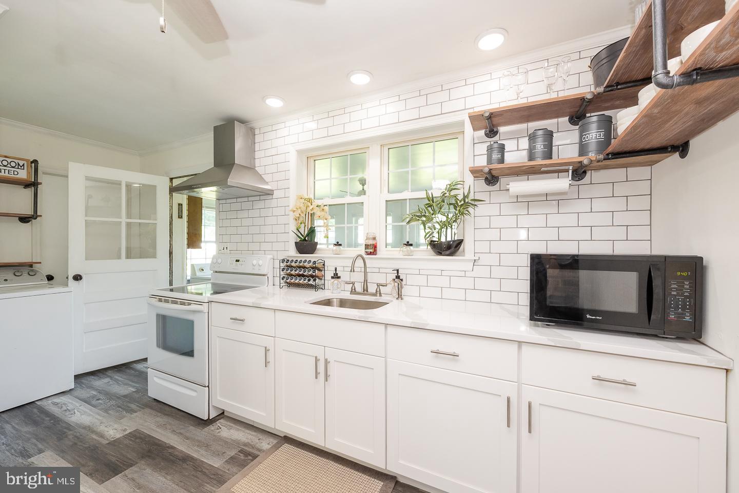 312 Lawrence Road Broomall, PA 19008 - Photo 10 of 23 a kitchen with stainless steel appliances granite countertop a stove a sink and a microwave