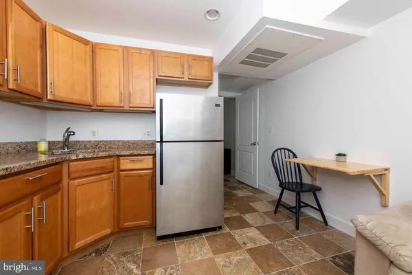 a kitchen with stainless steel appliances granite countertop a refrigerator sink and cabinets