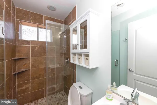 a bathroom with a toilet sink and shower