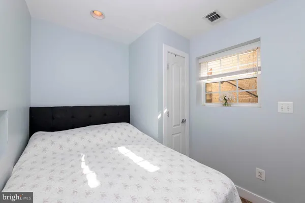 a bedroom with a bed and window