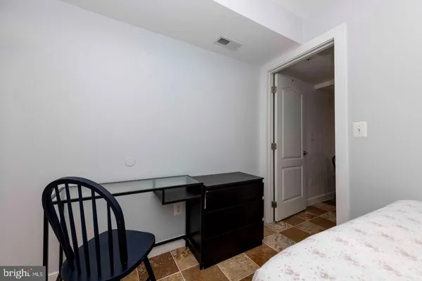 a bedroom with a bed and a mirror