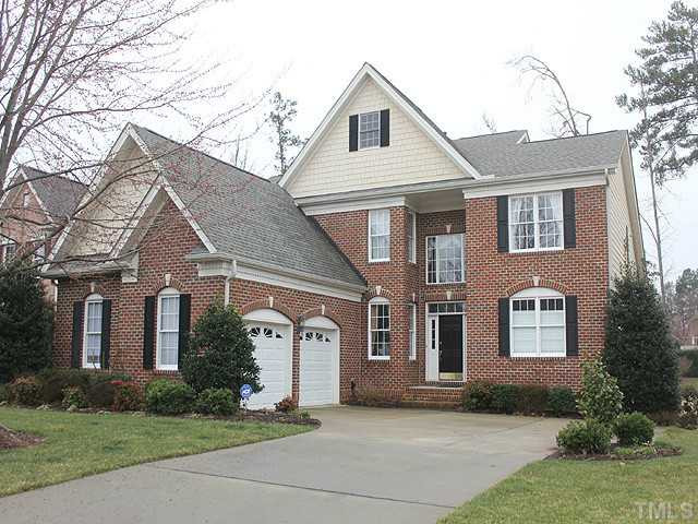 9137 Sanctuary Court Raleigh, NC 27617 - Photo 1 of 17 a front view of a house with a yard and garage
