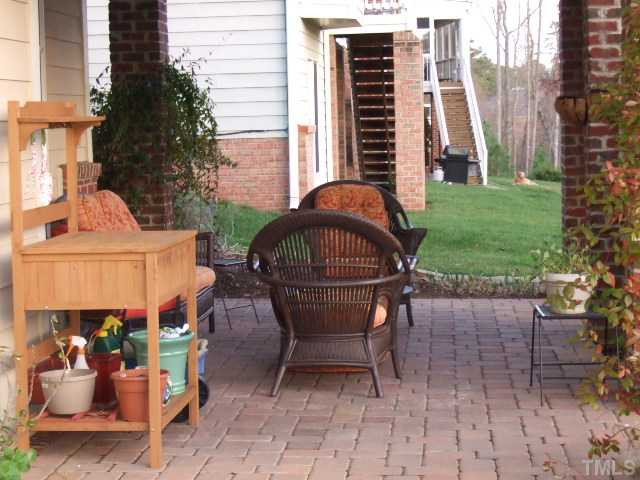 9137 Sanctuary Court Raleigh, NC 27617 - Photo 17 of 17 a view of a patio with a table and chairs
