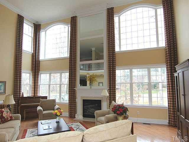 9137 Sanctuary Court Raleigh, NC 27617 - Photo 2 of 17 a living room with furniture and a fireplace