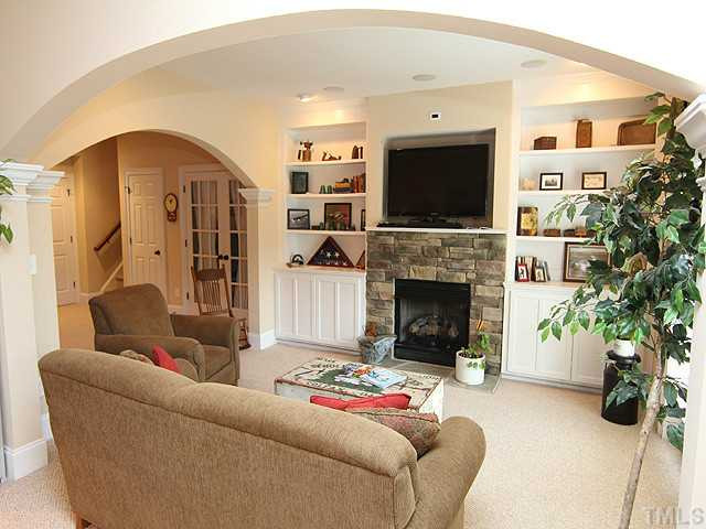 9137 Sanctuary Court Raleigh, NC 27617 - Photo 8 of 17 a living room with furniture and a flat screen tv