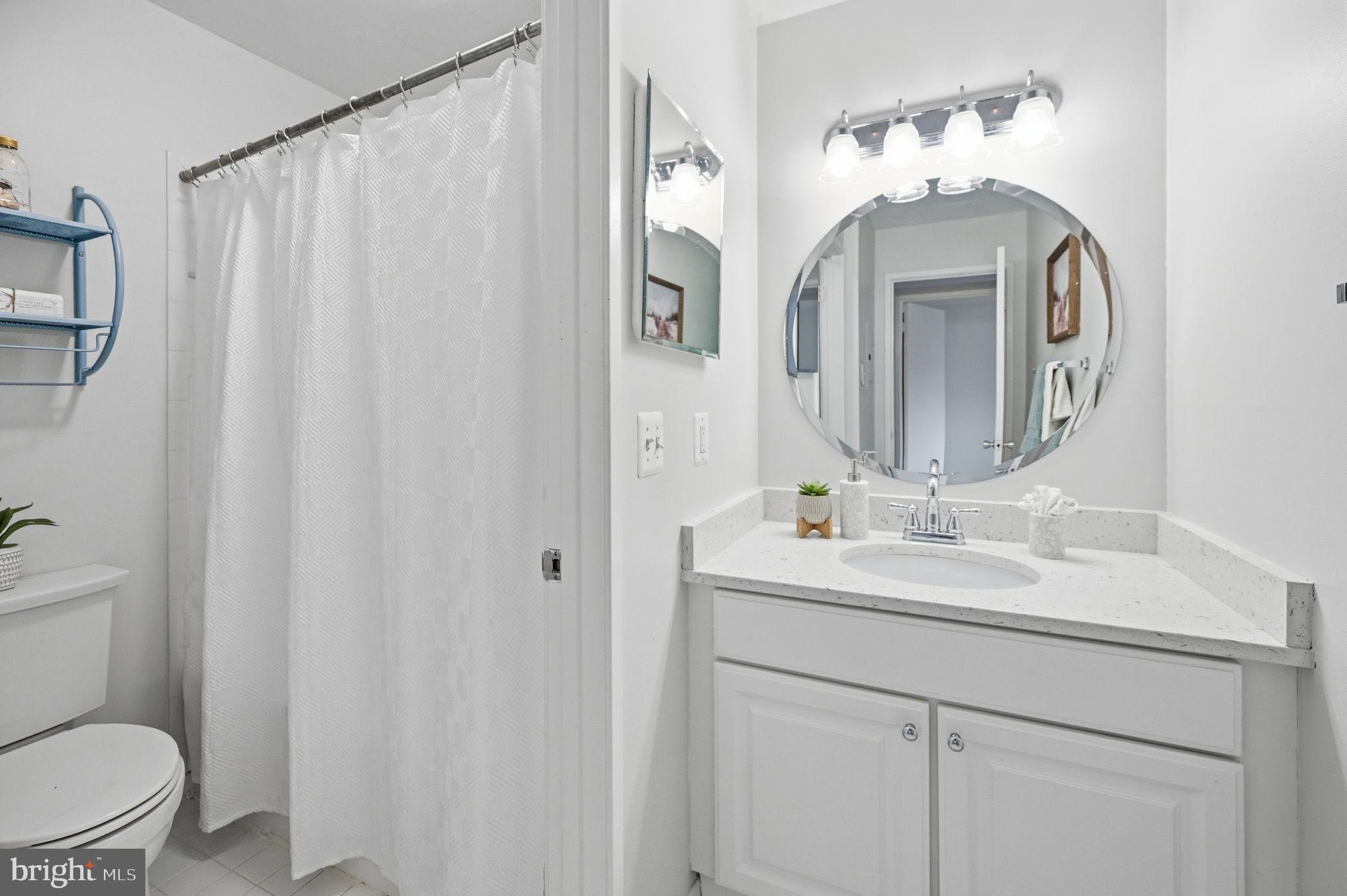 1659 Parkcrest Circle, Unit C Reston, VA 20190 - Photo 23 of 31 a bathroom with a toilet a sink and a mirror