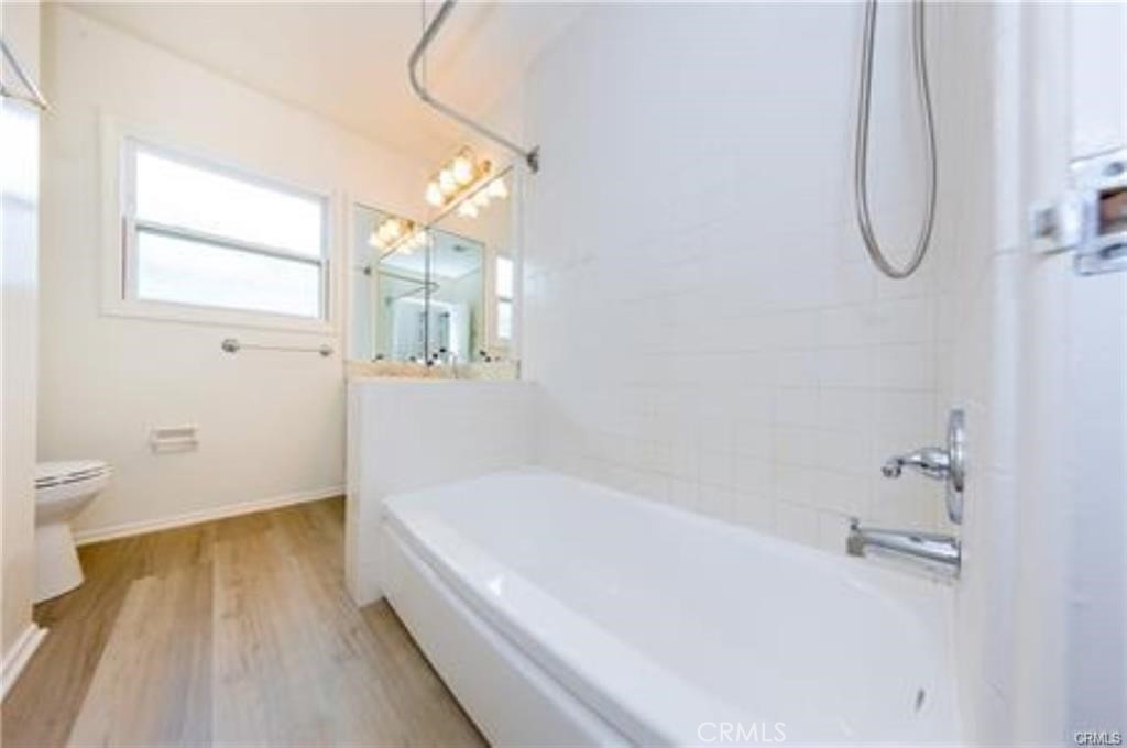 15853 Romar Street North Hills, CA 91343 - Photo 12 of 16 a white bath tub sitting next to a white toilet
