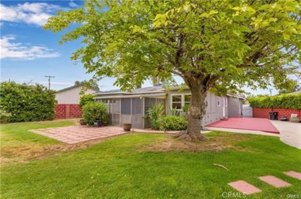 15853 Romar Street North Hills, CA 91343 - Photo 15 of 16 a front view of a house with a yard and trees