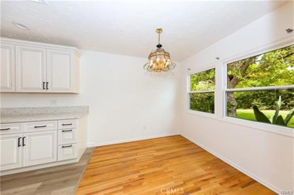 15853 Romar Street North Hills, CA 91343 - Photo 2 of 16 a view of empty room with wooden floor and fan