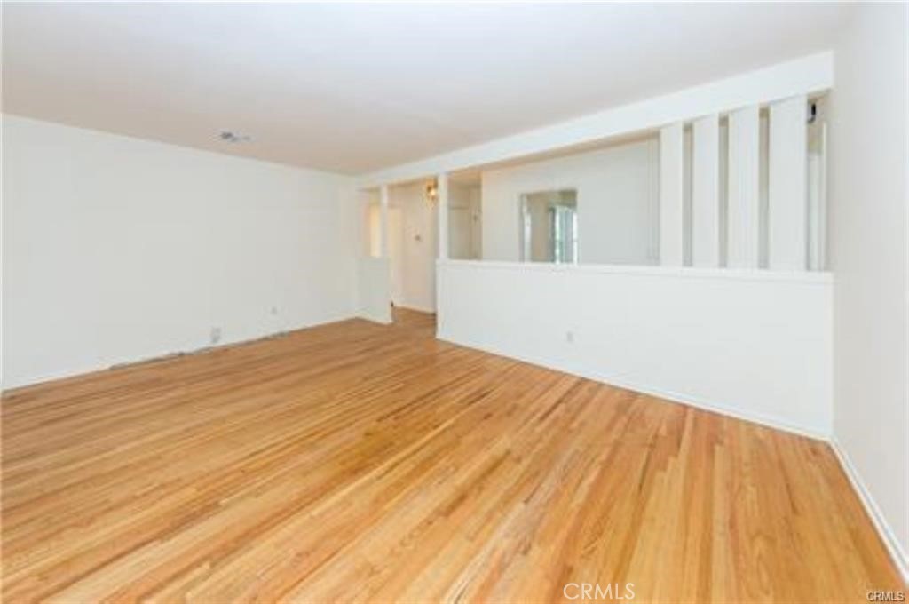 15853 Romar Street North Hills, CA 91343 - Photo 5 of 16 a view of empty room with wooden floor