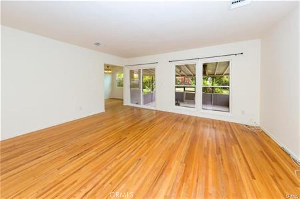 15853 Romar Street North Hills, CA 91343 - Photo 6 of 16 a view of empty room with wooden floor and fan
