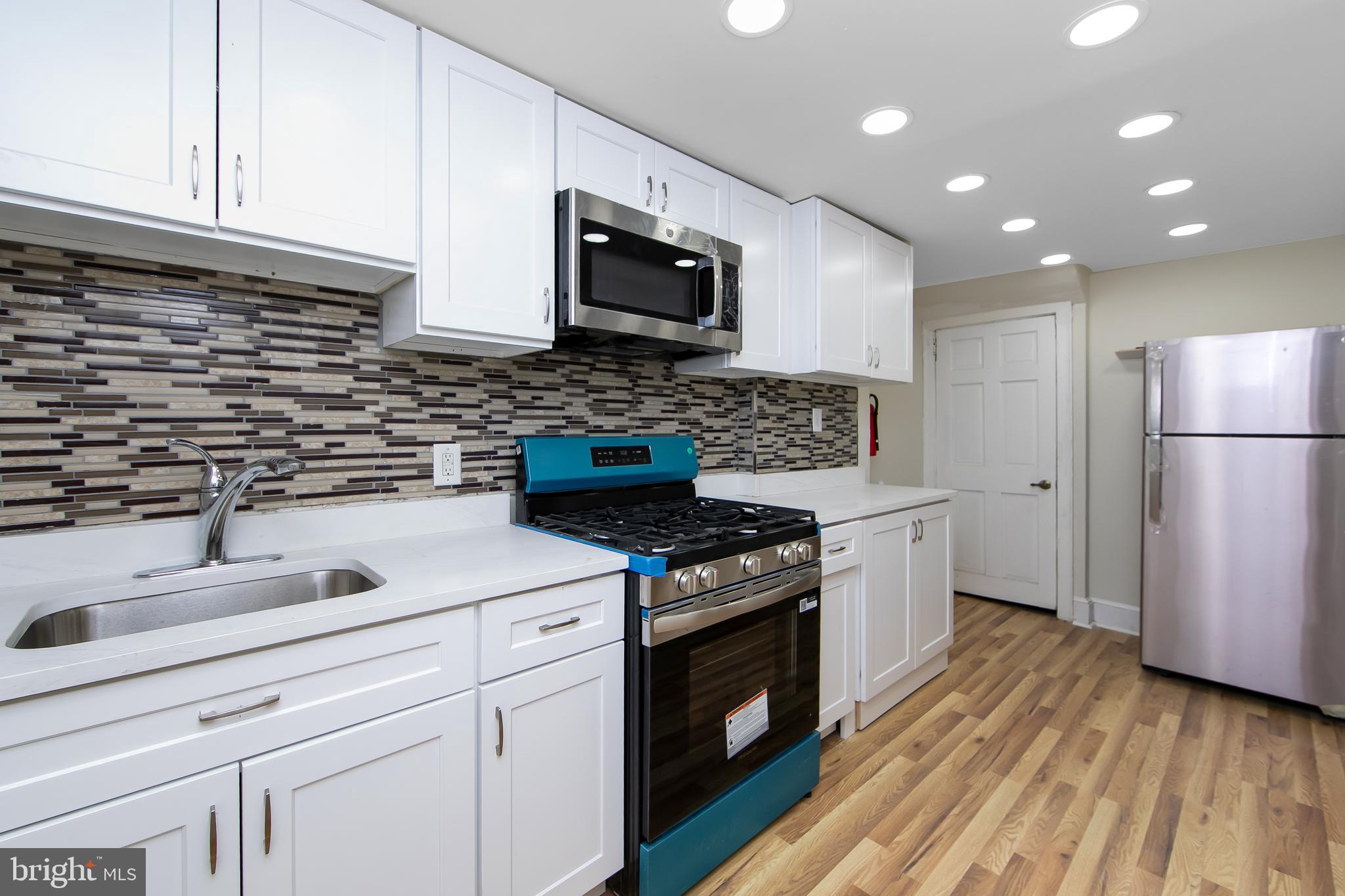 3156 Alabama Road Camden, NJ 08104 - Photo 13 of 31 a kitchen with a sink stove and refrigerator