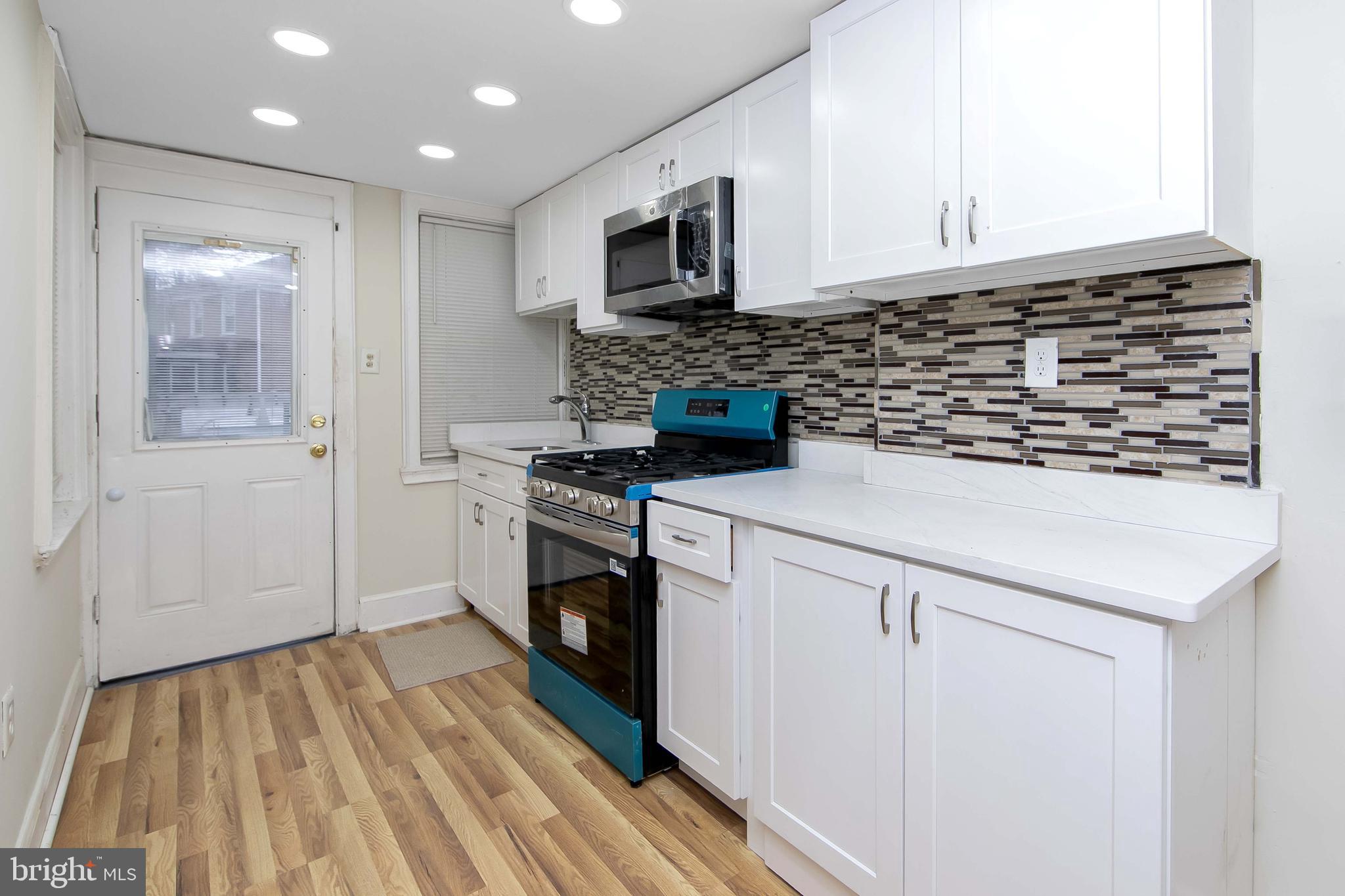 3156 Alabama Road Camden, NJ 08104 - Photo 15 of 31 a kitchen with a stove and a microwave