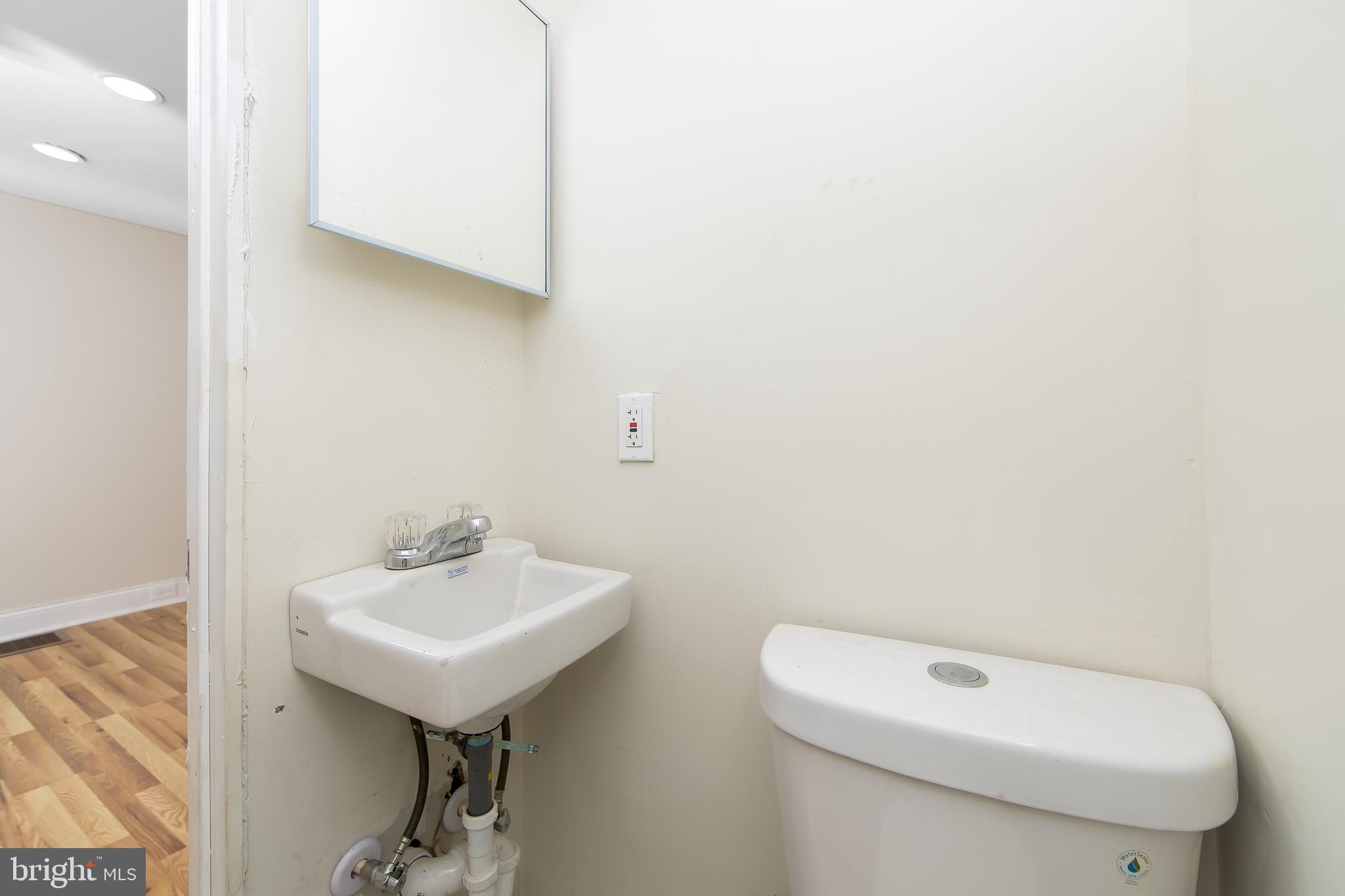 3156 Alabama Road Camden, NJ 08104 - Photo 17 of 31 a bathroom with a sink a toilet and mirror