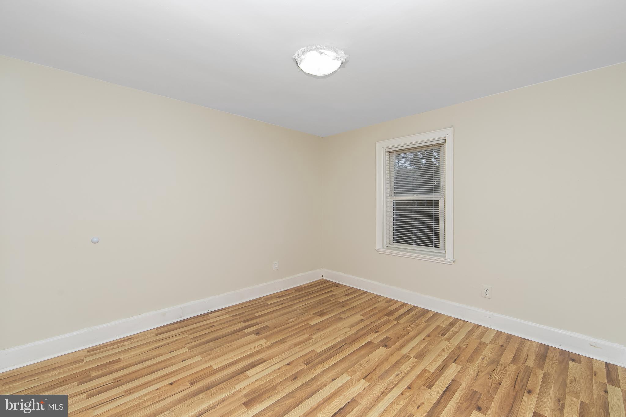 3156 Alabama Road Camden, NJ 08104 - Photo 18 of 31 a view of an empty room with wooden floor and a window