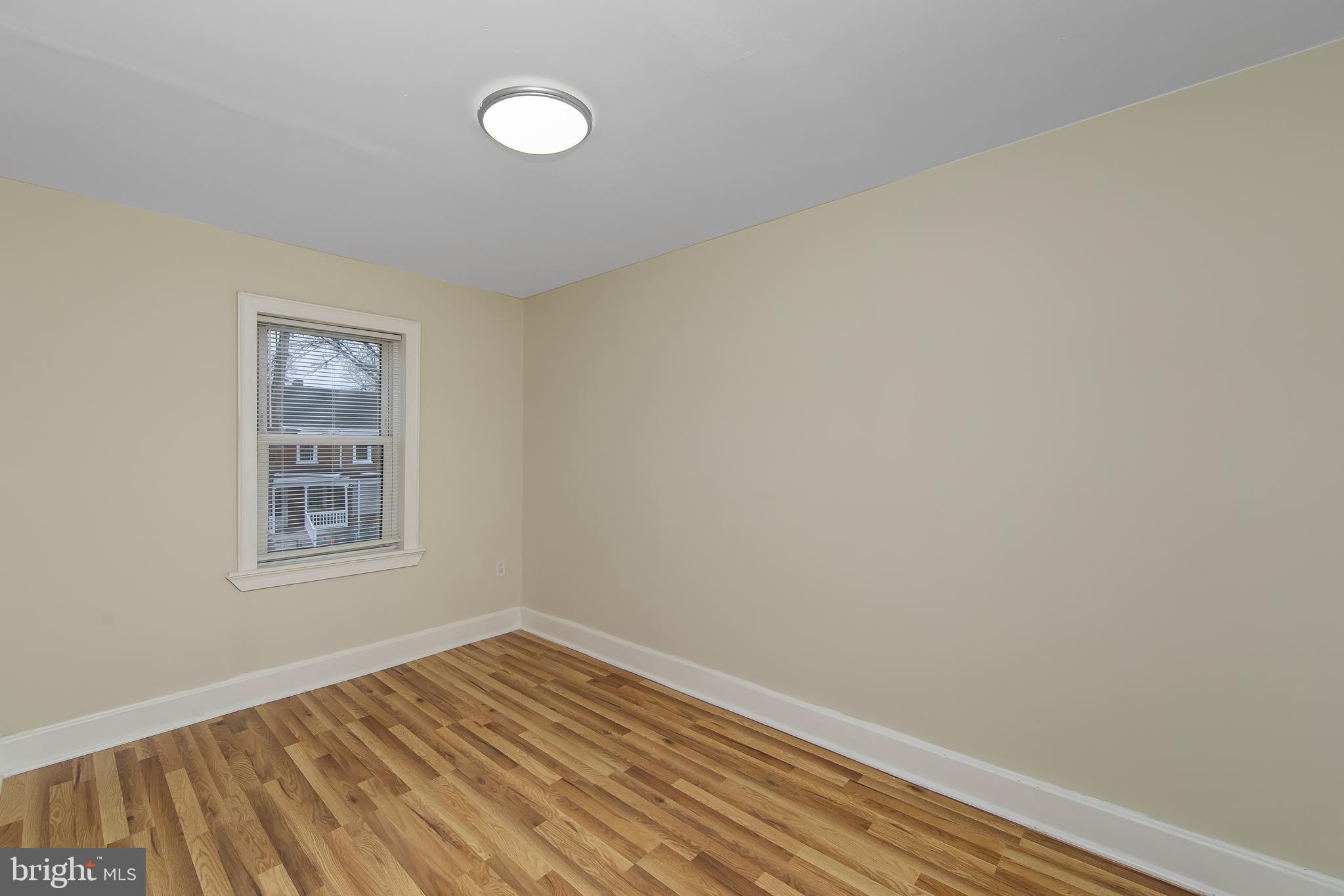 3156 Alabama Road Camden, NJ 08104 - Photo 21 of 31 a view of an empty room with wooden floor and a window