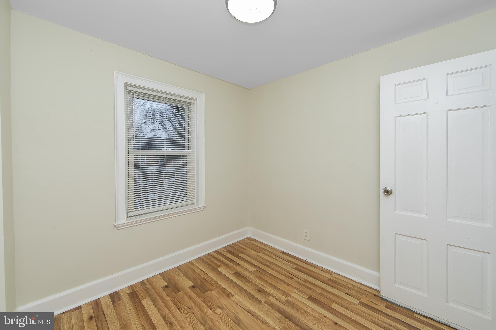 3156 Alabama Road Camden, NJ 08104 - Photo 26 of 31 an empty room with wooden floor and windows