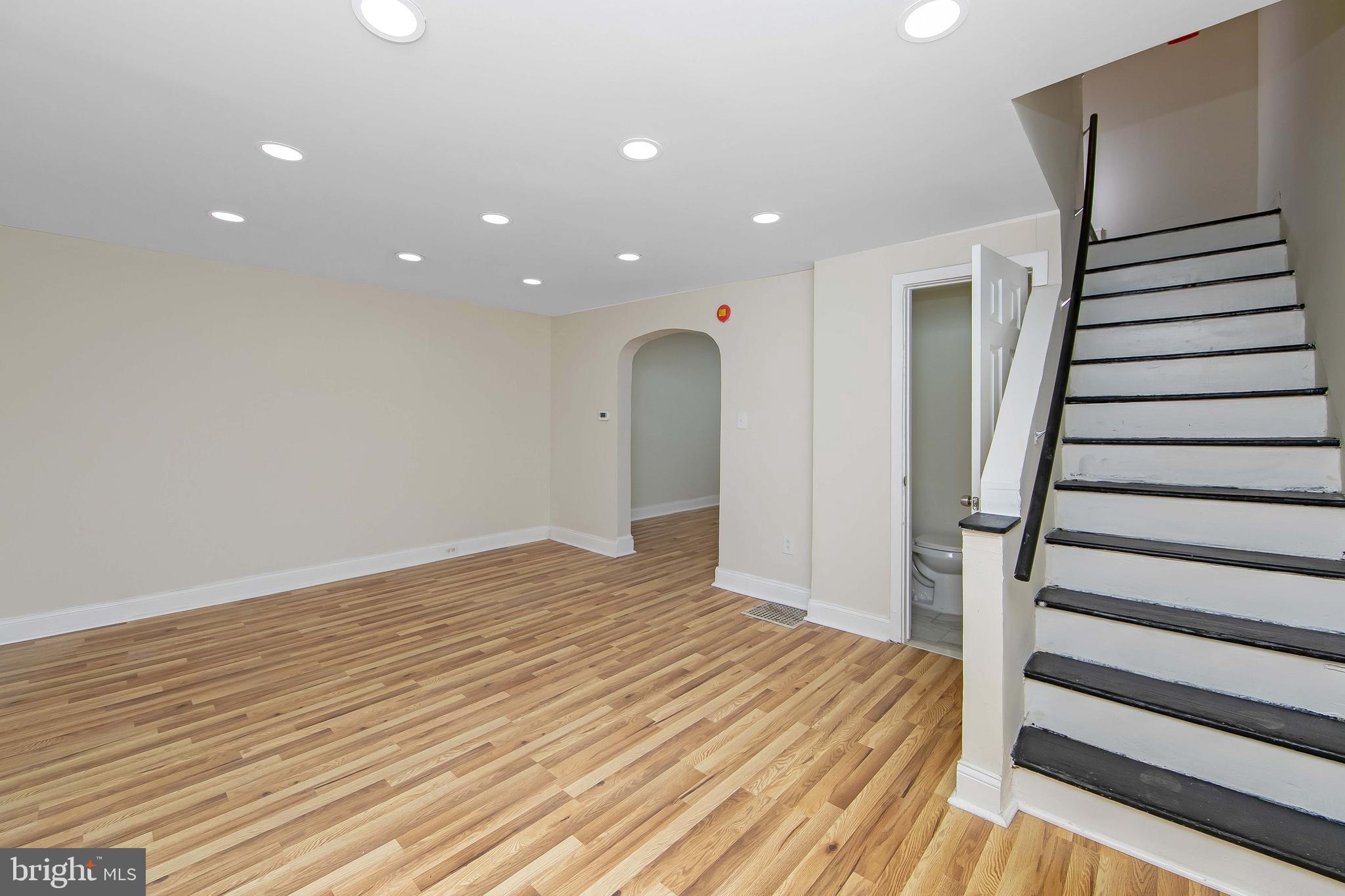 3156 Alabama Road Camden, NJ 08104 - Photo 6 of 31 a view of a livingroom with wooden floor and stairs