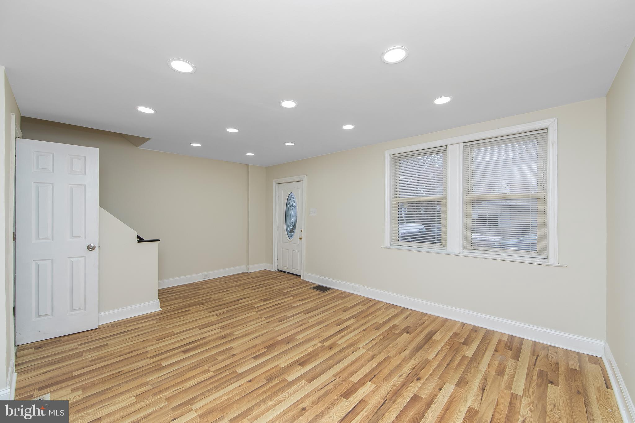 3156 Alabama Road Camden, NJ 08104 - Photo 8 of 31 a view of an empty room with wooden floor and a window