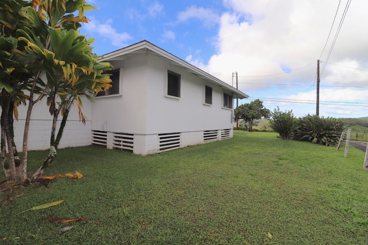 3434 Hailima Road Koloa, HI 96756 - Photo 13 of 13 a white house with tall trees in the background